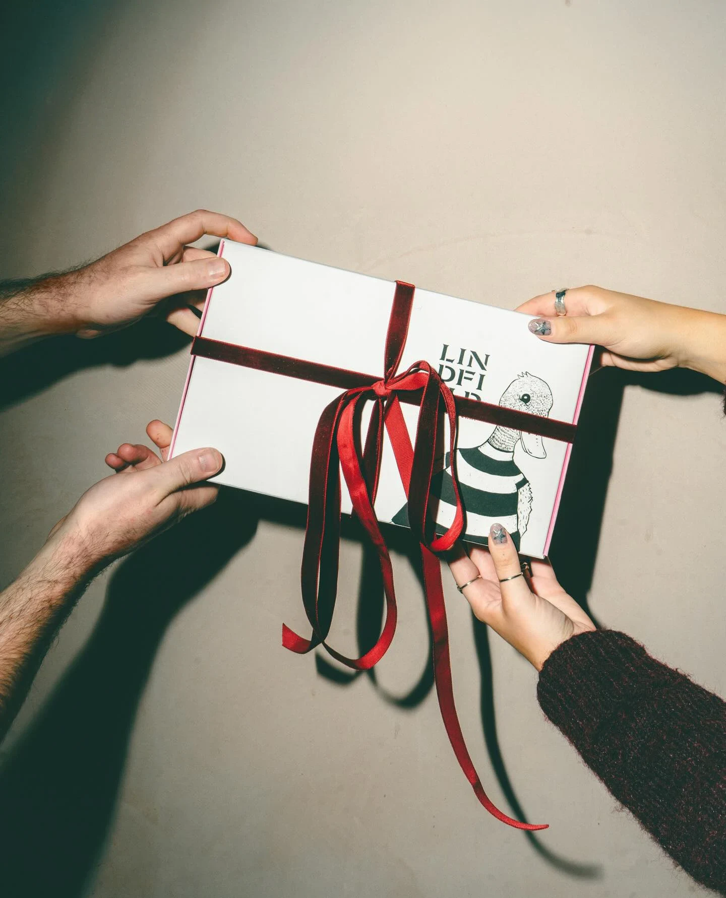 Gift box wrapped in red ribbon for Christmas packaging